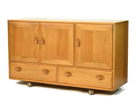 Modern Design - Ercol light elm sideboard, fitted three cupboard doors with two drawers below   Condition: 