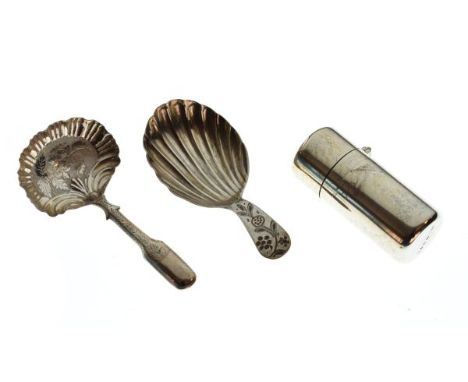 Three items of silver comprising a George III shell caddy spoon, no assay mark, an unmarked white metal caddy spoon, and a la