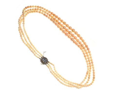 Graduated three string pearl choker having a diamond mounted oval clasp with central woven hair panel   Condition: 