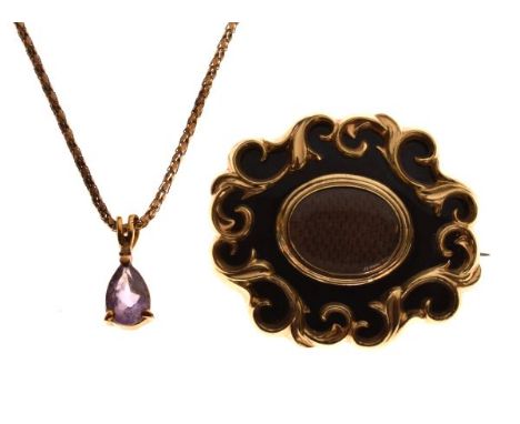 Victorian gilt metal mourning brooch having oval woven hair panel within a black enamel and scrolling foliate border, the rev