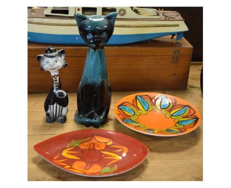 Two Poole pottery 'Delphis' pattern plates, the first shape 91 (oval leaf shape) with red ground, the second shape 4 (circula