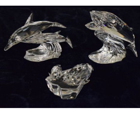 Three items of Swarovski comprising: Seal and cub on an ice shelf, Dolphin and calf on a wave, and a Whale (3)   Condition: 