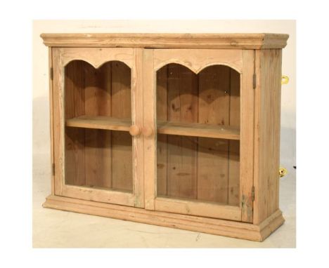 Vintage stripped table-top cabinet with a pair of double-arched glazed doors enclosing single shelf, 77cm wide   Condition: 