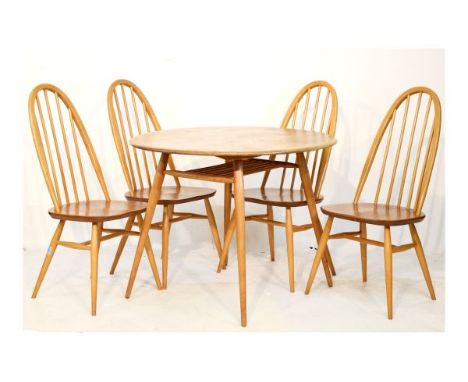 Modern Design - Ercol light elm and beech circular topped dining table standing on tapered supports united by an undershelf, 