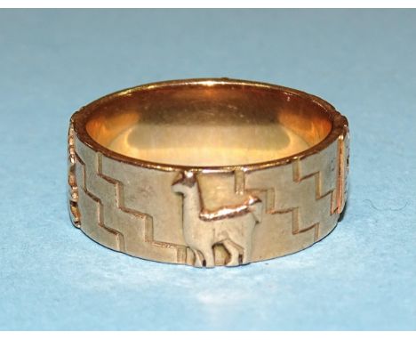 A gold ring with raised Inca symbols, size U, marked '18k', 10.3g. 