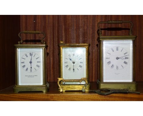 A brass carriage clock, the dial marked&nbsp;Hall &amp; Co, Paris,&nbsp;17cm high overall and two smaller brass carriage cloc