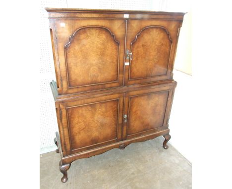 A walnut four-door drinks cabinet, 102cm wide, 150cm high. 