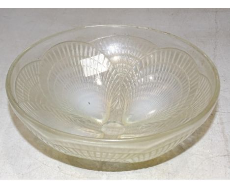A 1930 Lalique bowl in the 'Coquilles' pattern, with shell-moulded opalescent feet, 18cm diameter, 7.5cm high, etched 'R Lali