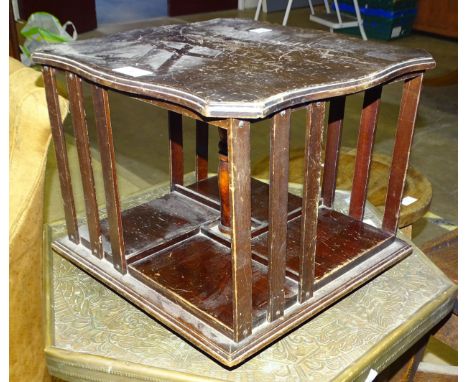A miniature mahogany revolving book case with metal label,&nbsp;Goodyears, Regent &amp; Bond Street, London,&nbsp;34cm square
