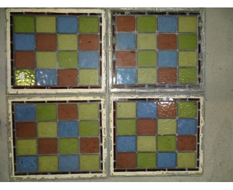 A collection of four leaded-light windows, each with sixteen blue, red, yellow and green 9.5 8cm glass sections, 48 x 41cm ov