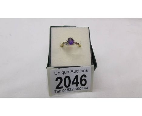 A 9ct gold ring set amethyst coloured stone, size P.