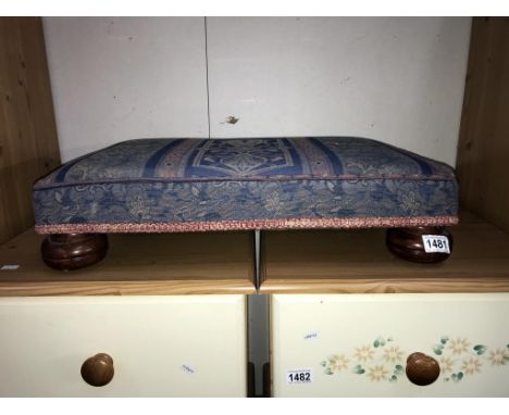 A tapestry covered foot stool