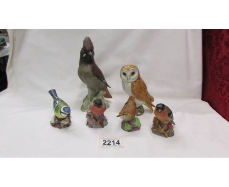 Four Royal Worcester birds, a Beswick owl and a Goebel bird.