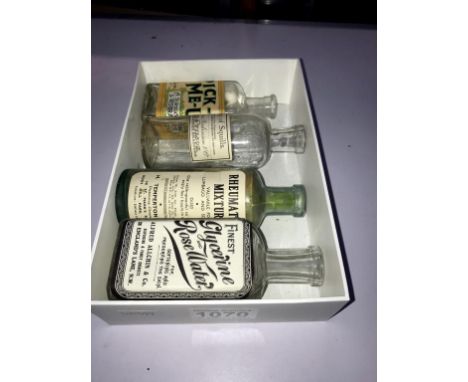 4 vintage bottles with paper label advertising