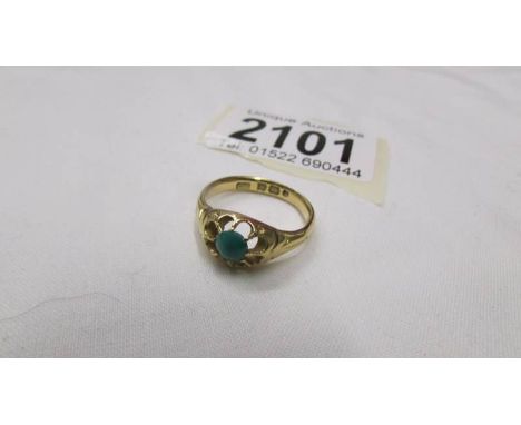 An 18ct gold ring set jade?, size N half.