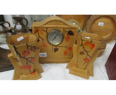 A 1930's ceramic three piece clock set.