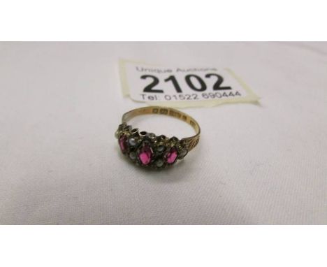 A 9ct gold seed pearl and garnet set ring, size N. ****Condition report**** No damage observed