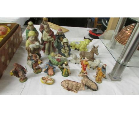 A quantity of ceramic and plastic nativity figures.