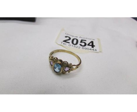 A 9ct gold ring set blue and purple stones, size V.