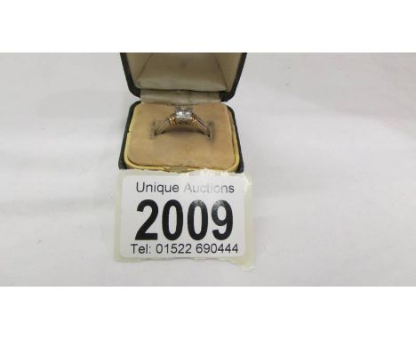 An 18ct white and yellow gold 90 pt square stone diamond ring.  Size M half.