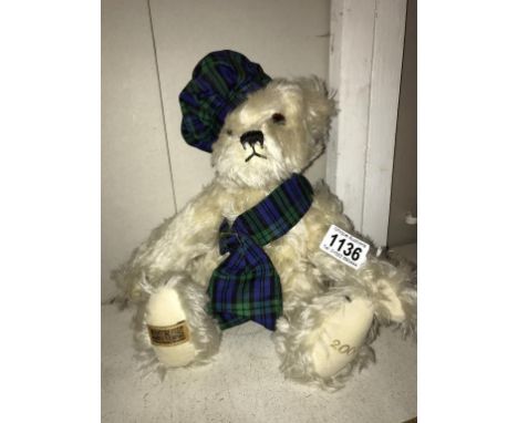 A Merrythought 2000 blond bear with growler tartan sash and hat