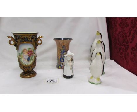 A Carlton ware vase, A Royal Worcester Nun candle snuffer, a set of three graduated penguins and another vase.