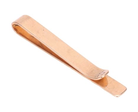 Cartier - a tie clip, in form of a plain polished bar, yellow metal signed and marked '14K', serial number rubbed, 5.4 cm lon