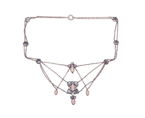 An Art Nouveau moonstone and opal swag necklace, with circular and oval cabochon stones in conforming mounts, suspended on an