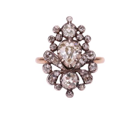An old-cut diamond cluster ring, the floral cluster panel is composed of a pear-shaped and two round old-cut diamonds in cut-