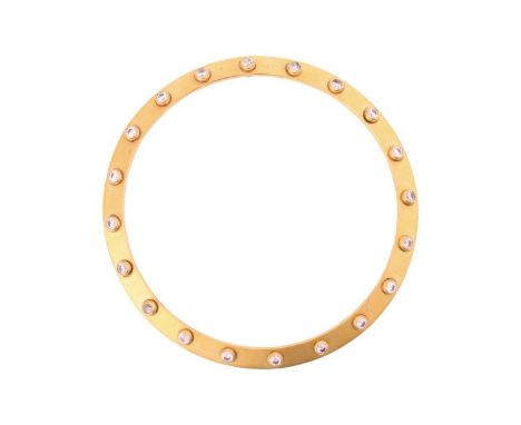 A riveted bangle, the round band comprises spinning rivets, set with CZs on both sides, in yellow metal marked '22KT', inner 