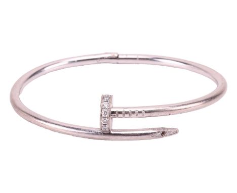 Cartier - a 'Juste un Clou' diamond-set bracelet in 18ct white gold, classic model, of a hinged bent nail motif, signed and n