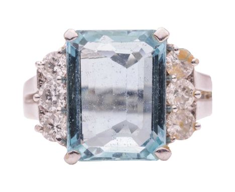 An aquamarine and diamond dress ring, featuring a rectangular step-cut aquamarine with canted corners, approximately measurin