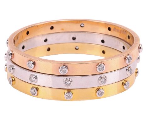 A set of three diamond-set bangles, each closed bangle set with twelve round-cut diamonds, each bangle with an estimated diam