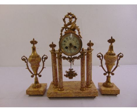 A French gilt metal and marble clock set, the circular enamel dial with Arabic numerals, supported by four columns and flanke