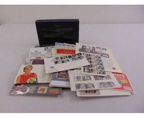 A quantity of first day covers, unused stamps and the Millennium collection