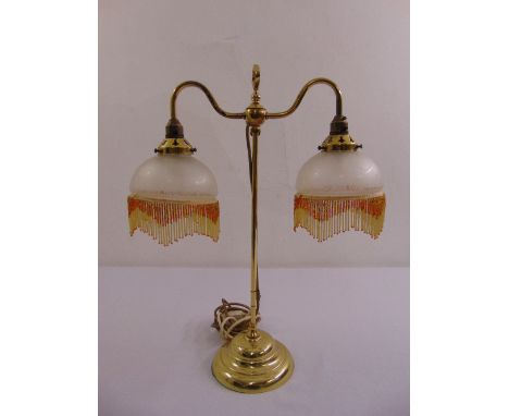 A brass two branch Victorian style table lamp on raised circular base