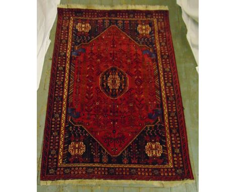 A Qashqai carpet red and black ground with stylised motifs and repeating patterns, 188 x 134cm