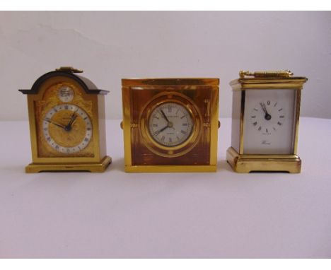 A Halcyon Days desk chronograph, a brass mounted carriage clock and a miniature bracket clock (3)