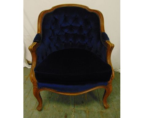 An early 20th century mahogany upholstered continental occasional chair on cabriole legs