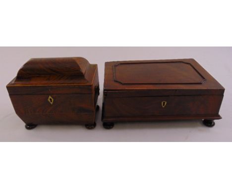 A mahogany tea caddy with domed cover and brass lion handles on bun feet and a rectangular mahogany jewellery box with fitted