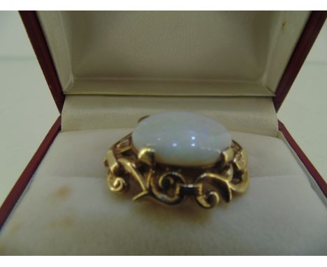 9ct gold brooch  with oval white Iridescent opal 12 grams total weight 