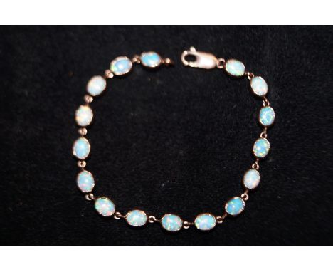 9ct Gold Opal Bracelet set with 16 Opals. Weight 10.4 grams