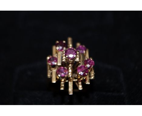 18 carat gold cluster ring set with 7 rubies. size M and weight 6g. 