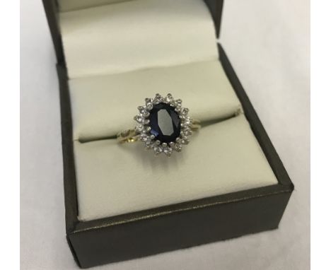 9ct gold sapphire cluster ring with central oval sapphire surrounded by small clear stones.  Ring size O, total weight approx