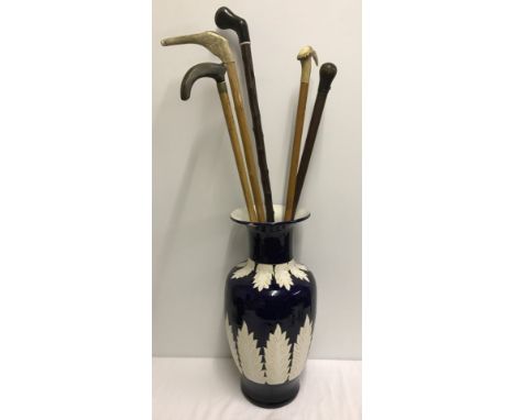 5 vintage wooden walking sticks in a large ceramic vase. Vase a/f 