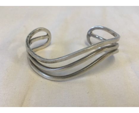A Wave design 925 silver bangle. Total weight 34.1g. 