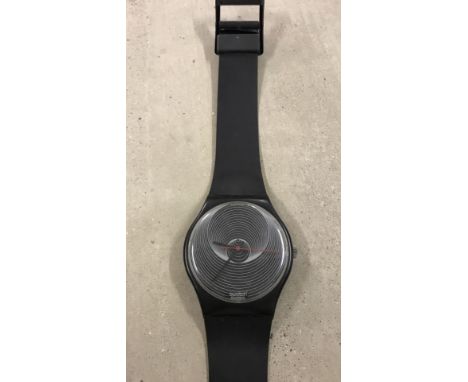 Vintage Swatch watch wall clock in the shape of a giant wrist watch. Black colouration with concentric circles design to cloc