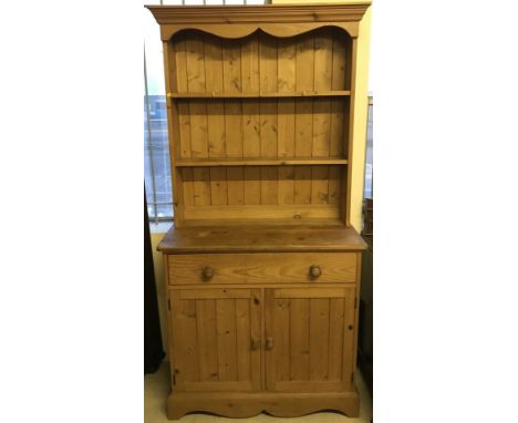 A vintage pine 2 part dresser. With 2 door, 1 drawer base and shelf top section. Approx. 90cm wide x 186cm tall.