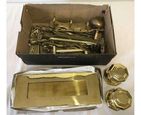 A box of assorted brass door and window fittings. To include letter plate, octagonal shaped door knobs and a fox head shaped 