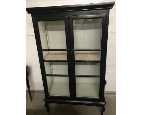 A large 3 shelved display cabinet, painted black. 2 movable glass shelves together with an internal wooden shelf. 